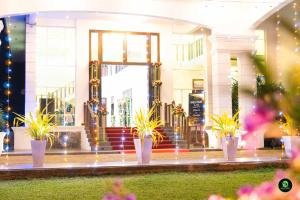 a building with potted plants in front of it at Soba Lanka Holiday Resort in Karandagolla +95 photos