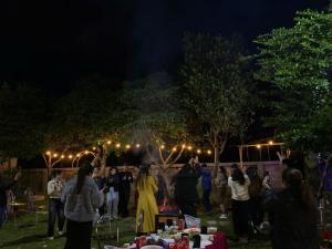 a group of people standing around a party at night at Phúc Hưng Homestay- Venuestay in Ba Vì +55 photos