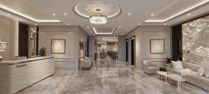 a lobby with couches and a reception desk in a building at Minasi Grand Hotel in Hanoi
