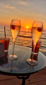 two glasses of wine on a tray on the beach at Diego Rooms Vlora in Vlorë