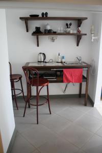 a kitchen with a table with two chairs and a sink at Trepimäe Guest Apartment in Viljandi