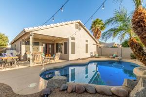 a house with a swimming pool in front of a house at 136th Surprise in Surprise