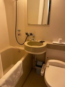 a bathroom with a sink and a toilet and a mirror at Hotel Nissin Kaikan - Vacation STAY 02353v in Shiso