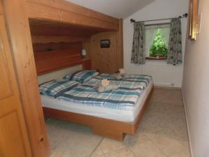 ミッテンヴァルトにあるFerienhaus Lippのベッドルーム1室(木製ベッドフレーム付きのベッド1台付)