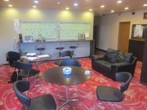 a meeting room with chairs and a table and a couch at Hotel Sankyu in Tsukuba