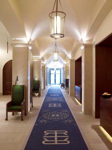 a hallway in a hotel with a carpet with chinese writing on it at Refinery Hotel - New York in New York