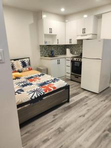 a small kitchen with a bed and a refrigerator at Private Balcony Studio Apartment for 5 People at Queen Street Downtown in Toronto