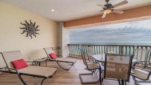 a balcony with chairs and a table and a sun clock at Sonoran Sun in Campo del Medio