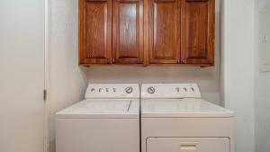a kitchen with a white stove and wooden cabinets at Sonoran Sun in Campo del Medio