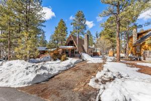 a home in the woods with snow at Mescalero Flagstaff in Munds Park