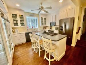 a kitchen with white cabinets and a black refrigerator at Henlopen avenue 58 in Rehoboth Beach