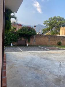 two white cats sitting in a parking lot at Casa HUEHUE in Tepoztlán