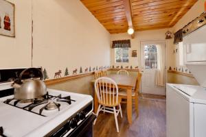 eine Küche mit einem Herd und einem Tisch mit einem Wasserkocher in der Unterkunft Dusk to dawn #557 in Big Bear Lake
