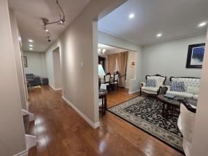 a living room with a couch and a table at Three Bedrooms House in Mississauga with free parking Conveniently located with easy access to the airport downtown Toronto major malls and highways for a seamless stay in Mississauga