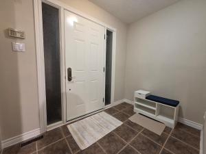 a room with a white door and a tile floor at Three Bedrooms House in Mississauga with free parking Conveniently located with easy access to the airport downtown Toronto major malls and highways for a seamless stay in Mississauga +32 photos