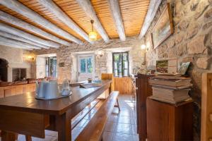a room with a wooden table with books on it at Gîte Le Moulin du Chambon 6/8 pers in Les Bessons