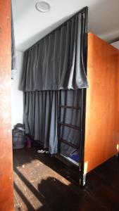 a bed with a black cover on top of it at WaterMellow Hostel in Ko Tao