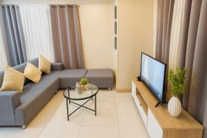 a living room with a couch and a tv at Camella Northpoint in Davao City