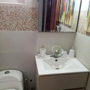 a bathroom with a white sink and a toilet at Prados de la Montana in Bartola
