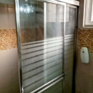 a shower with a glass door in a bathroom at Prados de la Montana in Bartola