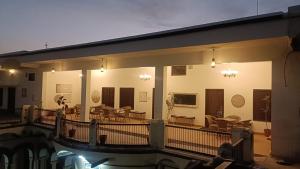 a house with a swimming pool at night at Khurja Wali Dharamshala in Rishīkesh