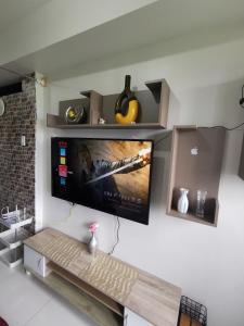 a flat screen tv hanging on a wall at Aldo mall of Asia condotel in Manila