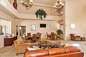 a living room with a leather couch and a dining room at Southern #2068 Mesa in Mesa