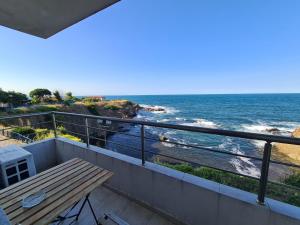 a balcony with a table and a view of the ocean at Casa DELL'ARTE in Ahtopol