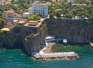 an aerial view of a building on a cliff over the water at Hotel Crawford in Sant'Agnello