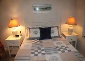 a bedroom with a bed with two lamps on both sides at Summerhouse 228 in Saint Augustine +30 photos
