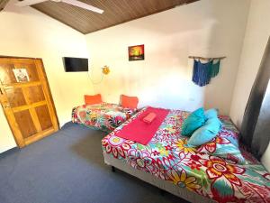 a bedroom with two beds and a door in it at Passifloras Hostel in Quepos