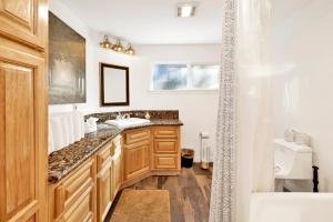 a bathroom with a sink and a bath tub at Conklin paradise #1993 in Big Bear Lake +20 photos