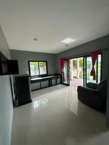 a large living room with a couch and a television at Rage Fight Academy in Pattaya South