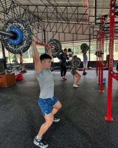 a young boy lifting weights in a gym at Rage Fight Academy in Pattaya South +14 photos