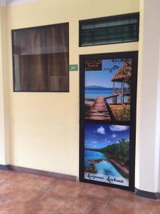 two doors with posters on the side of a building at Alojamiento D'Rosales in Cobán