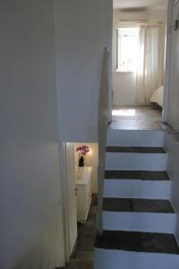 a staircase leading to a bedroom with a window at Ambelas Mare Apartments in Ambelas