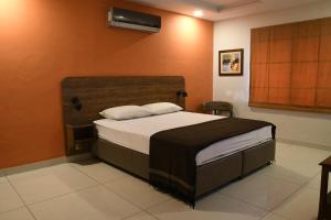 a bedroom with a large bed in a room at Morgah Resort - Guest Rooms in Rawalpindi