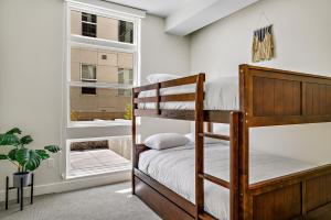 a bedroom with bunk beds and a window at Lofted Living | Espadin LoHi in Denver