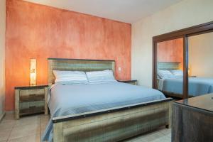 a bedroom with a bed and a mirror at Sonoran Sky in Puerto Peñasco +17 photos