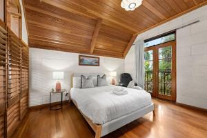 a bedroom with a bed and a wooden ceiling at 4BR Apollo Bay Beach house in Apollo Bay
