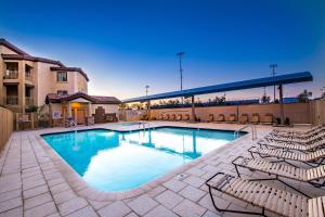 a swimming pool with lounge chairs next to a building at Southern #2068 Mesa in Mesa
