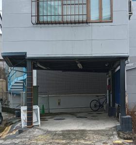a garage with a bike parked under a building at Aonoyado 碧の宿べっぷ駅前町 in Beppu