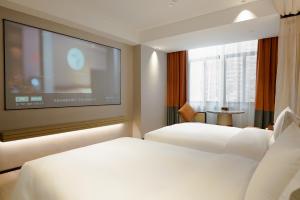 Postel nebo postele na pokoji v ubytování Paco Hotel Datang Metro Guangzhou-Close to Pazhou Exhibition Hall and free breakfast