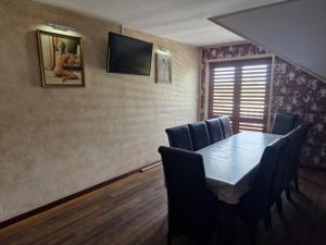 a conference room with a wooden table and chairs at Agrocentrum in Kobylany