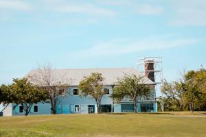 a blue building with a water tower on top of it at Atenas City Inn in Manati