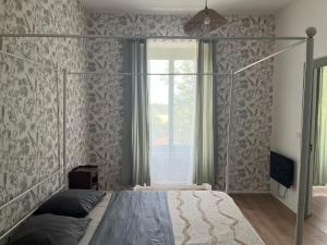 a bedroom with a canopy bed and a window at Domaine Le Chalet de Brousses in Brousses-et-Villaret +24 photos