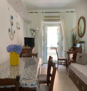 a dining room and living room with a table and chairs at Domvs Flavia in La Spezia