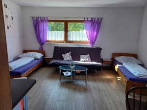 a living room with two beds and a couch at Apartmány Kojčice in Kojčice