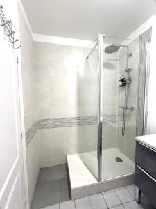 a shower with a glass door in a bathroom at Modern Home proche de Disneyland et Paris in Champs-Sur-Marne