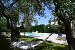 a hammock in a yard next to a swimming pool at Villa MEMA in Bisceglie